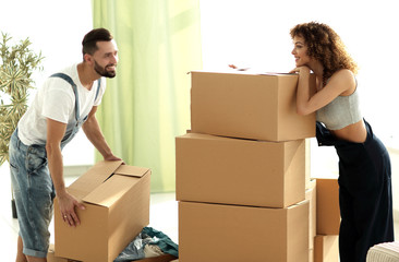 young couple unpacking boxes in a new house