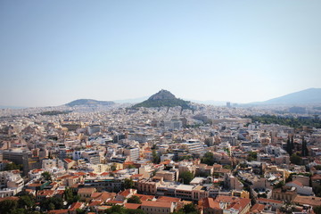 View over the city and the Lycabettus hill from Acropolis in Athens, Greece. Panorama of Athens . Beautiful cityscape with seashore