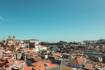Fototapeta na wymiar Porto in Portugal and its ancient and picturesque architecture of buildings and houses surrounding the Douro River
