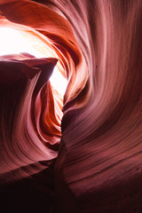 Bright rock waves of Antelope Canyon on light sky background