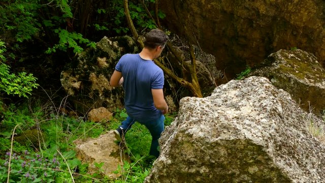 The man descends the rocky slope