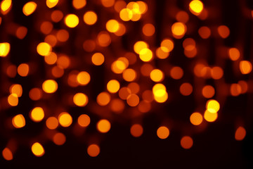 Blurred view of beautiful lights on dark background