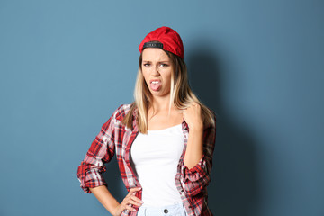 Disgusted young woman on color background