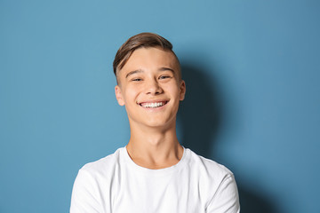 Smiling teenage boy on color background - Powered by Adobe