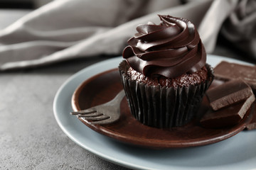 Delicious chocolate cupcake on plate, closeup