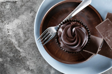 Delicious chocolate cupcake on plate