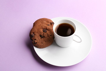 Cup with tasty aromatic coffee and cookies on color background