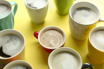 Many cups with tasty aromatic coffee on color background
