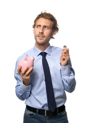Handsome man with piggy bank on white background