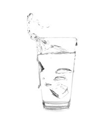 Glass with splashing water on white background