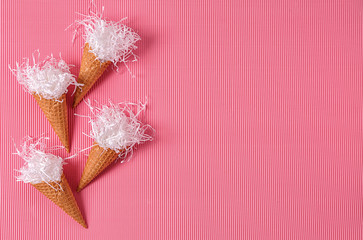Waffle cones with paper strips on color background