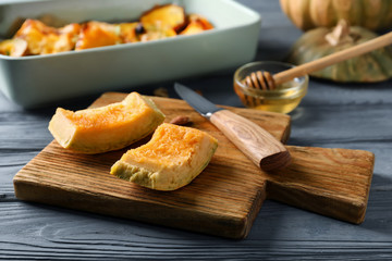 Raw pumpkin pieces on wooden board