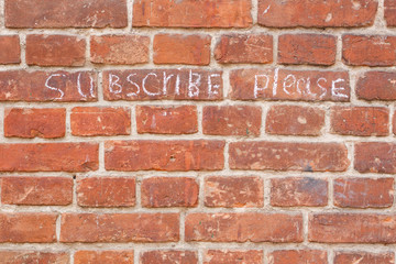 Fototapeta premium Text subscribe please on old vintage brick wall texture