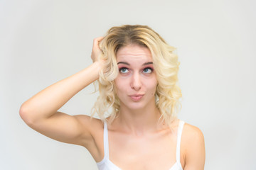Fototapeta premium Beauty portrait of a beautiful blonde girl on a white background with perfect makeup.