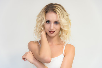 Obraz na płótnie Canvas Beauty portrait of a beautiful blonde girl on a white background with perfect makeup.