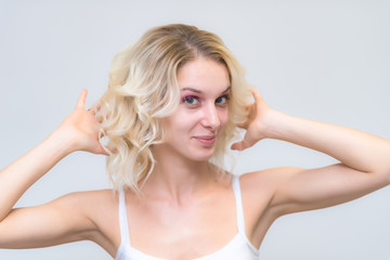 Fototapeta premium Portrait of a beautiful blonde girl while working as a professional beautician make-up artist.