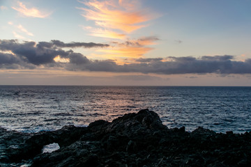 Sunrise over the Atlantic Ocean from Fuencaliente, La Palma with volcanic igneous rocks in the foreground