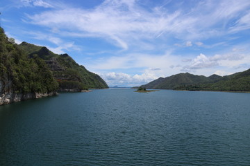 The beautiful landscape of hills covered with forests, and the sky was covered with clouds and the river.