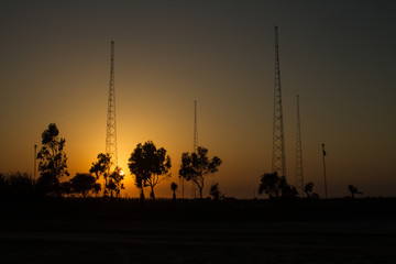 antennas in desert at sunset
