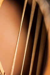 Close up shot sound hole and strings of acoustic guitar