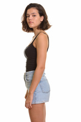 Profile view of young beautiful Caucasian teenage girl looking at camera