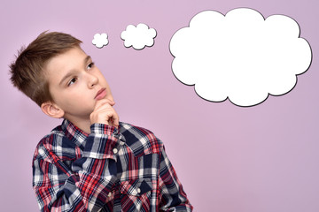 Thoughtful young boy with an empty thought bubble
