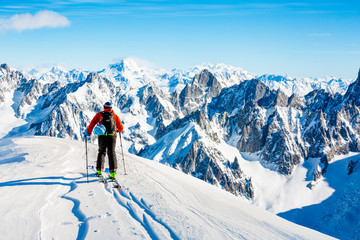 Fototapeta na wymiar Skitouring with amazing view of swiss famous mountains in beautiful winter powder snow of Alps. 