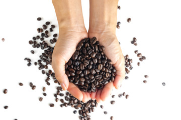 women hand gripping coffee beans. isolated top view on white background and clipping path.