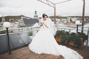 Beautiful bride spinning with perfect dress in the park