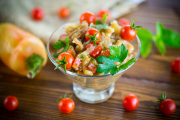 A warm salad of baked eggplant and peppers with cherry tomatoes