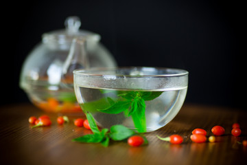hot tea from ripe red goji berries in a glass teapot