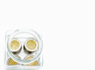 Money 10 Thai Baht is in a glass bottle. White background In the concept of saving money for the future.