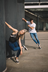 Fototapeta na wymiar couple of young dancers practicing on urban city street