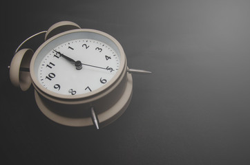 Close up.White Alarm clock isolated Placed on a Black background. copy space.