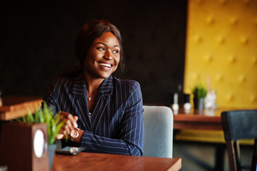 African american businesswoman sitting at table in cafe. Black girl having rest.