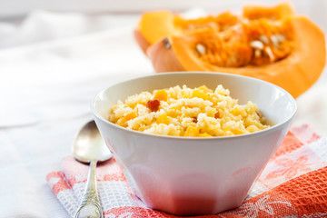 Milky cereal porridge with pumpkin and raisins
