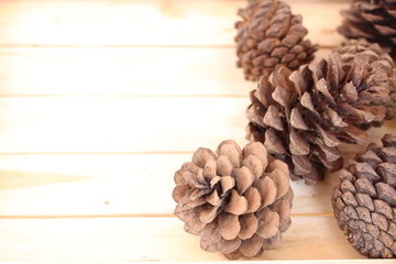 pine cones on the high light tone wood texture background for text concept of Christmas 2018  
