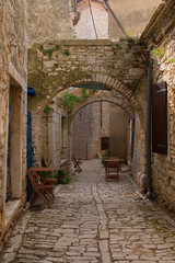 Fototapeta na wymiar A street in the historic hill village of Bale (also called Valle) in Istria, Croatia 