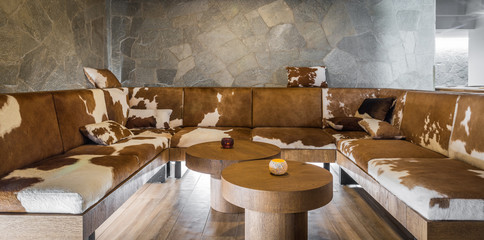 Big leather luxury sofa of cowhide in restaurant interior