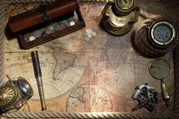 Fototapeta na wymiar Old ship lantern,compass,coins,monocle,loupe, sextants,rope and pirate map. Travel and marine engraving background. Treasure hood concept. Vintage style.