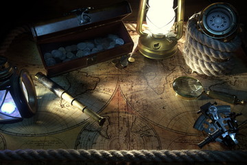 Old ship lantern,compass,coins,monocle,loupe, sextants,rope and pirate map. Travel and marine...