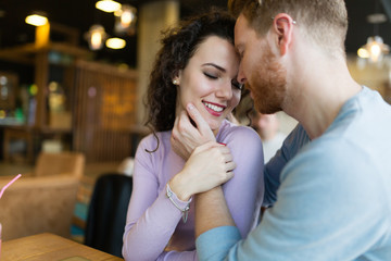 Young happy couple on date in coffee shop