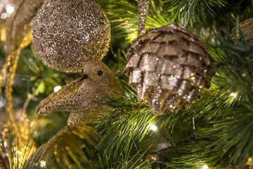 Christmas tree decorated with toys in golden