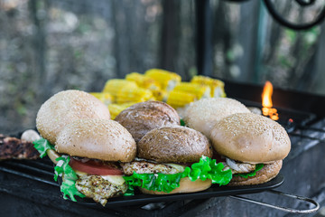 Grilled burgers outdoor. with cheese, onion, salad, tomato