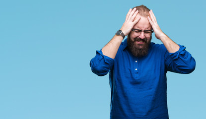 Naklejka premium Young caucasian hipster man wearing glasses over isolated background suffering from headache desperate and stressed because pain and migraine. Hands on head.