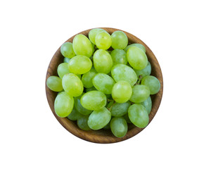 Grapes in a wooden bowl isolated on white background. Green grapes Kish Mish. Vegetarian or healthy eating. Top view.