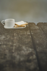 Breakfast set on wooden floor in the morning. Breakfast with coffee and bread.Do not focus on objects.Warm tone.