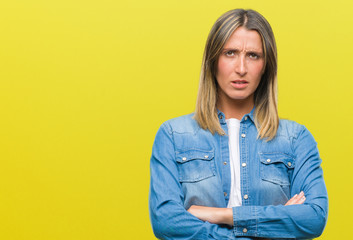 Young beautiful woman over isolated background skeptic and nervous, disapproving expression on face with crossed arms. Negative person.