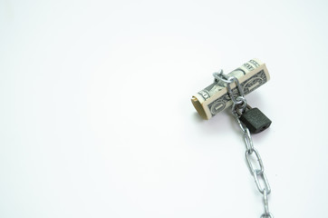Banknotes tied to chains with lock White background.Do not focus on objects..