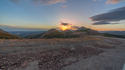 Fantastic sunset with the sun setting between the mountains in the area of Gordon, Leon (Spain)